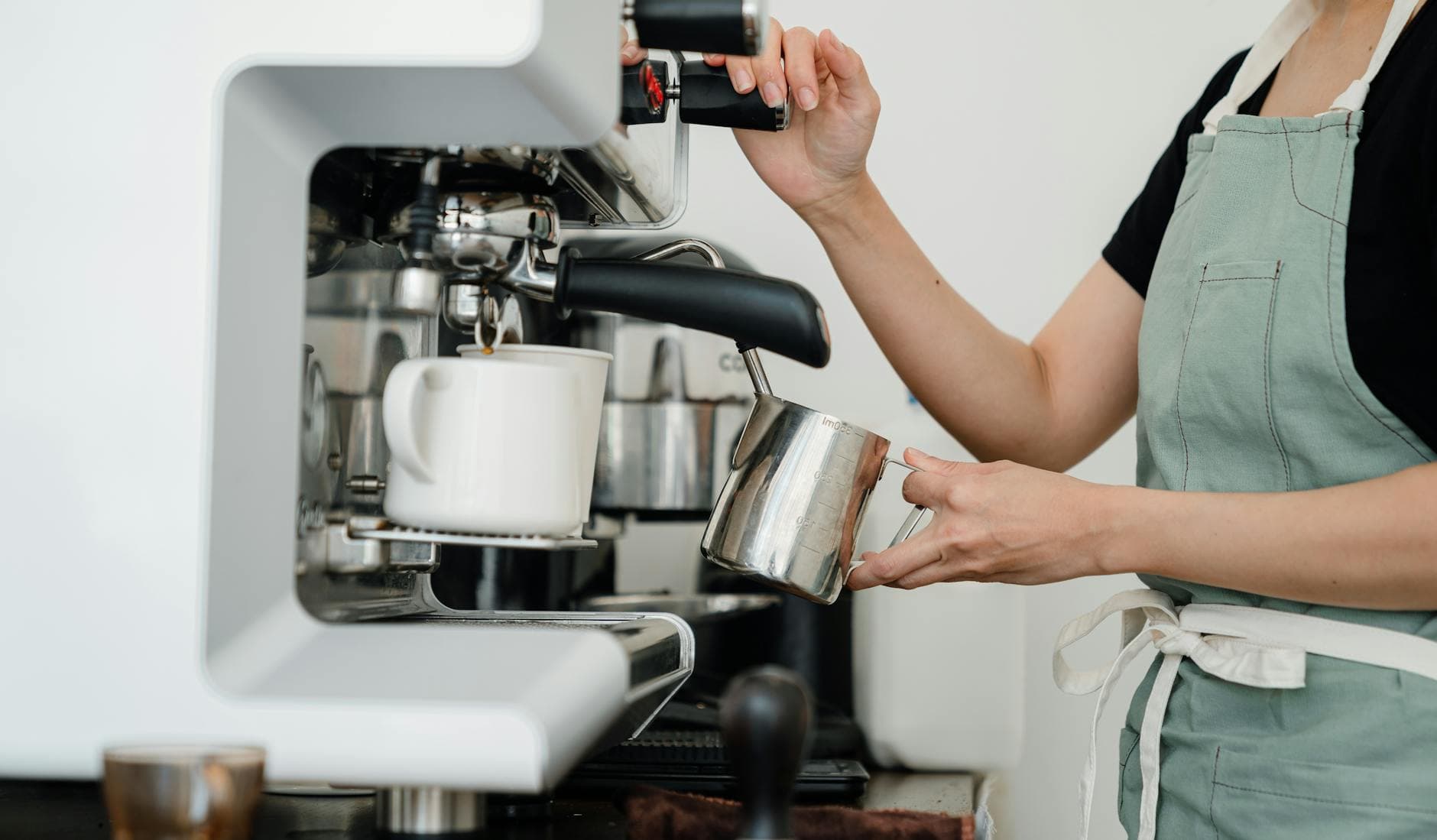 Barista making espresso at a machine